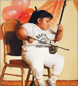  ??  ?? Jiang Yingxi, from Jiangxi province, performs the erhu (Chinese two-string fiddle) at an event in Beijing.