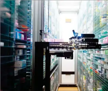  ?? FRED DUFOUR/AFP ?? This file photo taken on July 23, 2013, shows a robot retrieving medicines in the pharmacy of the Argenteuil hospital, in Argenteuil, a Paris suburb.