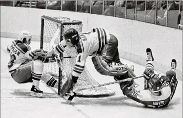  ?? RON FREHM / AP 1983 ?? The Rangers’ Mark Pavelich (left) slides into the net after a goal by the Capitals’ Doug Jarvis (right) on Dec. 7, 1983 at Madison Square Garden. Pavelich, who played parts of seven seasons in the NHL and is the only U.S.-born player in league history with a five-goal game, died March 4 at a treatment center for mental illness in Minnesota.