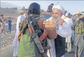  ?? AP FILE ?? Taliban fighters celebrate the Eid ceasefire with residents of Nangarhar province on June 16.