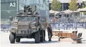  ?? TOLGA BOZOGLU, EPA ?? Turkish policemen secure an area Thursday with barriers in front of an Istanbul courthouse.