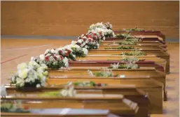  ?? ALESSANDRO SERRANO/GETTY-AFP ?? Coffins of migrants who died on Italy’s Calabrian coast are seen Tuesday at a sports arena converted into a makeshift morgue in Steccato di Cutro.