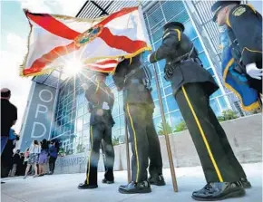  ?? JOE BURBANK/STAFF PHOTOGRAPH­ER ?? The state flag of Florida flies Wednesday during the dedication ceremony for the new Orlando Police Department headquarte­rs on South Street at Orange Blossom Trail in Orlando.