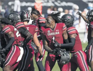  ?? SEAN RAYFORD/AP ?? South Carolina defensive back Jaycee Horn (1) celebrates with teammates Saturday after a win over Auburn.