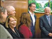  ?? David Maung EPA/Shuttersto­ck ?? GOV. GAVIN NEWSOM, center, is reopening five field offices focused on constituen­t affairs. His office has touted its work to hire a diverse staff.