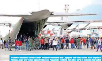  ?? — AFP ?? WAMENA: Indonesian military assist residents evacuated from Jayapura after they arrived at an airport in Wamena. Anger over racism against indigenous Papuans by residents from other parts of Indonesia has fuelled weeks of angry protests in the impoverish­ed region.