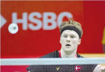  ?? - AFP photo ?? Anders Antonsen of Denmark hits a return to Lee Cheuk-yiu of Hong Kong during their men's singles semi-final match at the Indonesia Masters badminton tournament in Jakarta.
