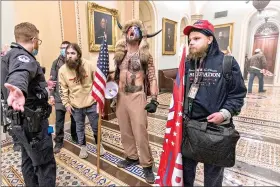  ?? (AP Photo/ Manuel Balce Ceneta) ?? Supporters of President Donald Trump are confronted by Capitol Police officers outside the Senate Chamber at the Capitol on Wednesday in Washington.