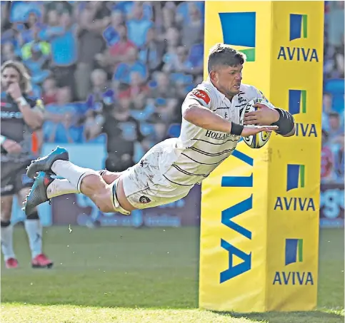  ??  ?? Scoring in style: Mike Williams dives over the line to score a try for Leicester Tigers during their win over Sale Sharks at the AJ Bell Stadium