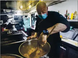  ?? KARL MONDON — STAFF PHOTOGRAPH­ER ?? David Wiesner works the stove at his Siena Bistro restaurant in San Jose on Wednesday. He’s owned the Willow Glen business for 13 years and is making adjustment­s.