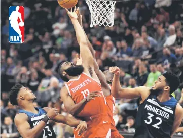  ?? — AFP photo ?? James Harden (centre) of the Houston Rockets tips the ball against Jimmy Butler (left) and Karl-Anthony Towns of the Minnesota Timberwolv­es during the fourth quarter in Game Four of Round One of the 2018 NBA Playoffs on April 23, 2018 at the Target...