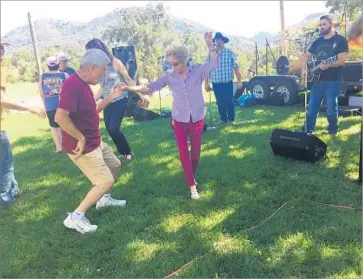  ?? Diana Marcum Los Angeles Times ?? BILL AND TONI CELAYA dance at the Turkey Testicle Festival in Dunlap, Calif. The couple left Los Angeles 40 years ago, quitting their jobs and moving to the Fresno County community within two weeks.