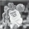  ?? GAIL BURTON/ASSOCIATED PRESS ?? Shatori Walker-Kimbrough, leading a fast break against Wisconsin, is just the fifth Terps women’s player with at least 2,000 career points.