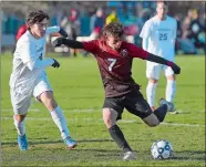  ?? SARAH GORDON/THE DAY ?? Fitch’s Sebastian Duffy (7) takes a shot on goal as Ryan Karp of Pomperaug defends during a CIAC Class L boys’ soccer game on Wednesday at Poquonnock Plains Park. Please go to theday.com to view a photo gallery.