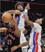  ?? Carlos Osorio Associated Press ?? JAMES WISEMAN of the Pistons blocks a shot by Toronto forward Thaddeus Young from behind.