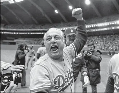  ?? GRIMSHAW — THE ASSOCIATED PRESS FILE ?? Los Angeles Dodgers manager Tom Lasorda celebrates after the Dodgers beat the Montreal Expos for the National League title in Montreal, in this Oct. 19, 1981, file photo. Lasorda, who guided the Los Angeles Dodgers to two World Series titles, has died. He was 93.