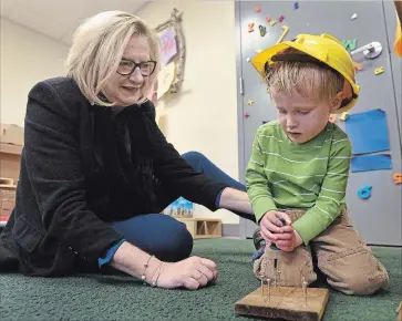  ?? BARRY GRAY THE HAMILTON SPECTATOR ?? Renee Wetselaar, new executive director at St. Matthew’s House, plays with Locke Robinson, 2, in the daycare. “You’re seeing a revitaliza­tion,” says Renee, of Barton Street. “Young people moving in (to the neighbourh­oods), and people coming from Toronto.”
