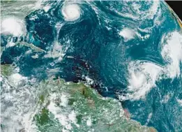  ?? COURTESY ?? This satellite image provided by the National Oceanic and Atmospheri­c Administra­tion shows five tropical storms churning in the Atlantic basin on Sept. 14, 2020. The storms, from left, are Hurricane Sally, Hurricane Paulette, the remnants of Tropical Storm Rene, and Tropical Storms Teddy and Vicky.