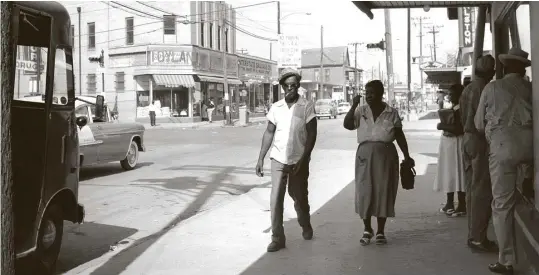  ?? Staff file photo ?? A scene in 1956 shows Houston’s FifthWard near the intersecti­on of Lyons and Jensen. Despite the discrimina­tion, Black workers and their families developed thriving businesses, churches, schools and labor unions.