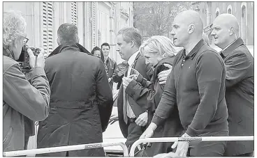  ?? — Reuters photo ?? Le Pen (centre) and Dupont-Aignan, leave by a backdoor from the Cathedral in Reims, surrounded by bodyguards, France.