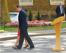  ??  ?? British Prime Minister David Cameron and his wife Samantha walk back into 10 Downing Street, London, after speaking to the media on Friday.