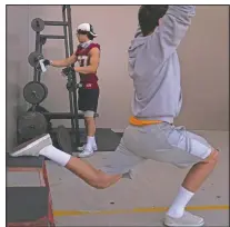  ??  ?? El Modena tight end Owen Mull hangs his mask on a weight bar while working out at a school gym temporaril­y set up at outdoor racquetbal­l courts before the game.