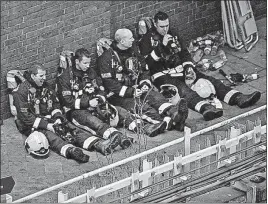  ?? [MATT DUNHAM/THE ASSOCIATED PRESS] ?? Firefighte­rs take a break from battling the massive fire that swept through the Grenfell apartments.