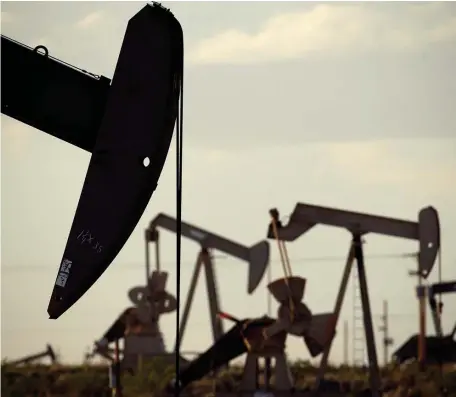 ?? AP FILE PHOTOS ?? QUICK THINKING: Pumpjacks work in a field near Lovington, N.M., in 2015. In the closing months of the Trump administra­tion energy companies stockpiled enough drilling permits for western public lands to keep pumping oil for years, despite President Biden’s plans to limit the drilling.