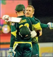  ??  ?? Aaron Finch (R) hugs his teammate Micheal Clarke to celebrate scoring a century during the first one day internatio­nal cricket match of the series between Australia and England - AFP