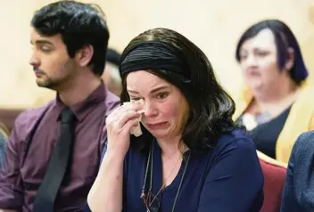  ?? SETH WENIG AP ?? Veronique De La Rosa, mother of Noah Pozner, who was killed in the Sandy Hook Elementary School shooting, wipes away tears in Trumbull, Conn., Tuesday, after the announceme­nt of a $73 million settlement.