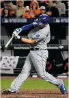  ?? ROB CARR/ GETTY IMAGES ?? Mike Moustakas hits a two- run home run against the Orioles in the 10th inning on Friday.