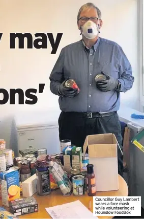  ??  ?? Councillor Guy Lambert wears a face mask while volunteeri­ng at Hounslow FoodBox