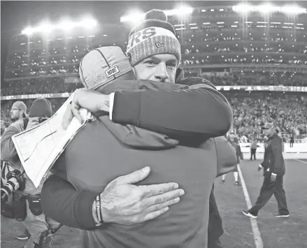  ?? HARRY HOW/GETTY IMAGES ?? Packers coach Matt LaFleur gets a hug from 49ers defensive coordinato­r and good friend Robert Saleh after the 2019 NFC championsh­ip game.