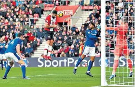  ??  ?? Hang man: Southampto­n striker Charlie Austin heads his second goal yesterday