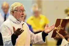  ??  ?? Reverend Malcolm Twine reads the gospel at the 10am Easter Sunday service at St Luke's Anglican Church,