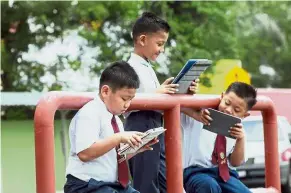  ??  ?? Tech-savvy: Primary students busy with their tablets. The idea of having a technology stream in school may sound exciting to children who are deeply interested in this field.