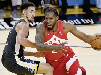  ??  ?? RAPTORS forward Kawhi Leonard (2) drives around Golden State Warriors guard Klay Thompson during the first half of Game 4 of basketball’s NBA Finals, Friday, June 7, 2019, in Oakland, Calif. (AP)