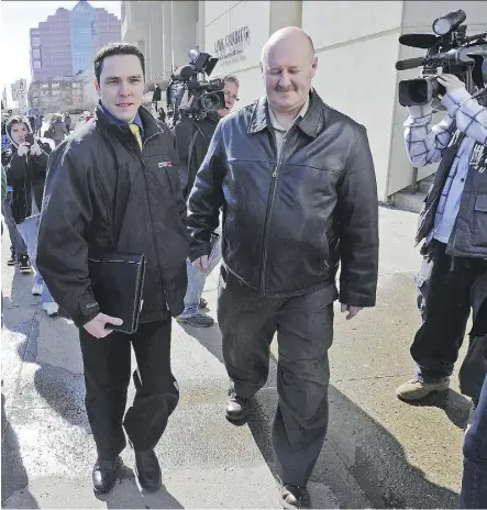  ?? ED KAISER ?? Gilles Tetreault, left, walks out of the courthouse in April 2011 with Edmonton Detective Bill Clark. Tetreault says he was lured to a garage and attacked by Mark Twitchell in 2008.