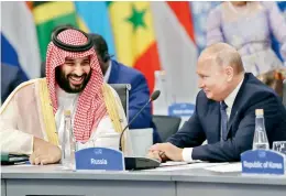  ?? — AFP ?? Saudi Arabia’s Crown Prince Mohammed bin Salman and Russian President Vladimir Putin share a light moment at the G20 Leaders Summit in Buenos Aires.