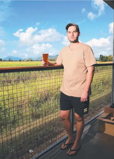  ?? Picture: JUSTIN BRIERTY ?? LOOMING DOUBT: Luke Hanlon takes in the view of Smithfield canefields. The council will decide on the fate of a proposed subdivisio­n behind Macalister Brewing this morning.