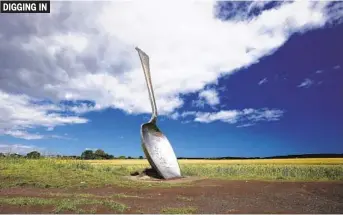  ?? CHRISTOPHE­R FURLONG GETTY IMAGES ?? Eat For England, a 15-foot spoon created by artist Bob Budd, sits between two farmers’ fields on Wednesday in Cramlingto­n, United Kingdom. The sculpture was commission­ed in 2006.