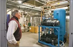  ?? MORGAN TIMMS/Taos News ?? Director of plant operations Dennis Fox shows the new vacuum pumps on Dec. 9 at Holy Cross Medical Center. The mill levy funding allowed Holy Cross Medical Center to replace the original system, which was installed in 1993. ‘If this stuff is not working properly you can’t provide heating and cooling, you can’t provide water pressure,’ Fox said. ‘It’s part of the system that gets overlooked but it’s a very important part.’