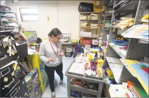  ?? Matthew Brown / Hearst Connecticu­t Media ?? Michele Migliaccio, a long-term substitute art teacher at Newfield Elementary, checks her cart before leaving a storage room to teach art on May 10. The school had to vacate six of its portable classrooms in October due to issues with mold.