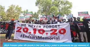  ?? ?? ABUJA: Protesters gather with placards in their hand, during a protest to commemorat­e one year anniversar­y of EndSars, a protest movement against police brutality at the Unity Fountain in Abuja yesterday. — AFP