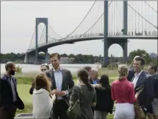  ?? MARK LENNIHAN — ASSOCIATED PRESS FILE ?? In this June 11, 2018 photo, President Donald Trump’s sons, Eric Trump, third from left, and Donald Trump Jr., second from right, talk with guests at the opening of the Trump Golf Links clubhouse in the Bronx borough of New York.