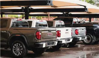  ?? David Zalubowski/Associated Press ?? Unsold 2023 Sierra pickups sit in a lot at a GMC Truck dealership last Thursday in Lone Tree, Colo. Vehicle prices are starting to drop now that supply-chain issues are fading.