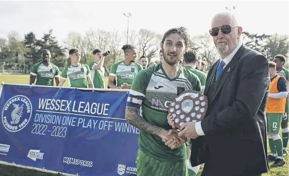  ?? Picture by Robin Caddy. ?? Connor Hoare receives the Wessex League Division 1 play-off trophy after his side’s penalty shoot-out win at New Milton