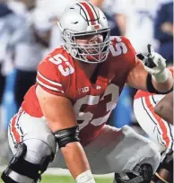  ?? JOSHUA A. BICKEL/COLUMBUS DISPATCH ?? Ohio State center Luke Wypler prepares to snap against Akron.