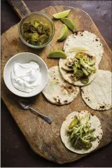  ?? MILK STREET ?? This image released by Milk Street shows a recipe for chile verde tacos with turkey.