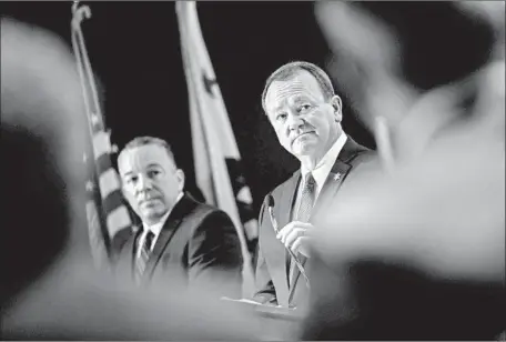  ?? Photograph­s by Marcus Yam Los Angeles Times ?? SHERIFF Jim McDonnell, right, and retired Sheriff ’s Lt. Alex Villanueva, his challenger for the post, debate Monday.